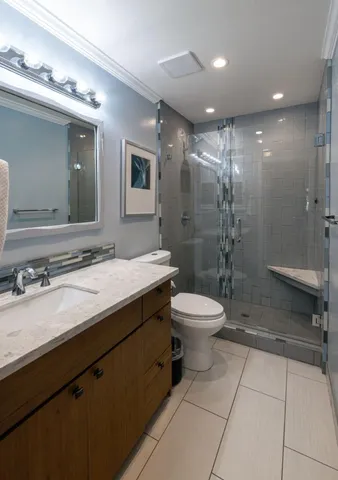 a bathroom with a sink toilet vanity and shower