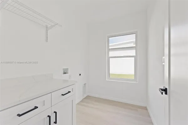 a room with a white cabinets and a window