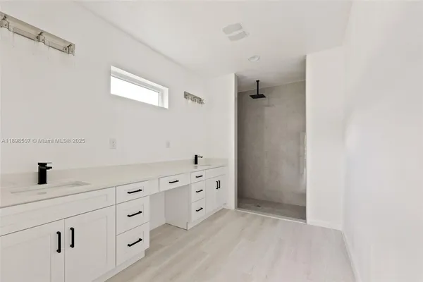 a bathroom with a bathtub sink and mirror