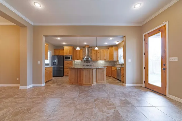 a view of kitchen with refrigerator and large window