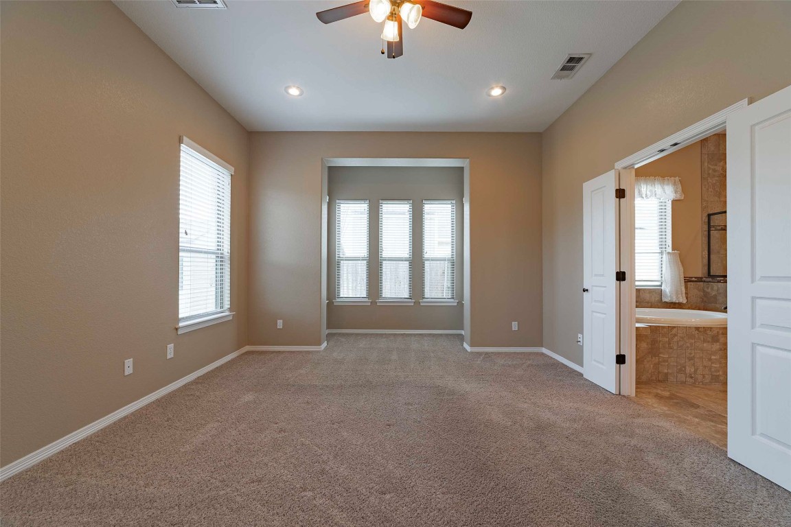 125 Walter Way Jarrell, TX 76537 - Photo 20 of 40 Carpeted empty room with plenty of natural light and ceiling fan