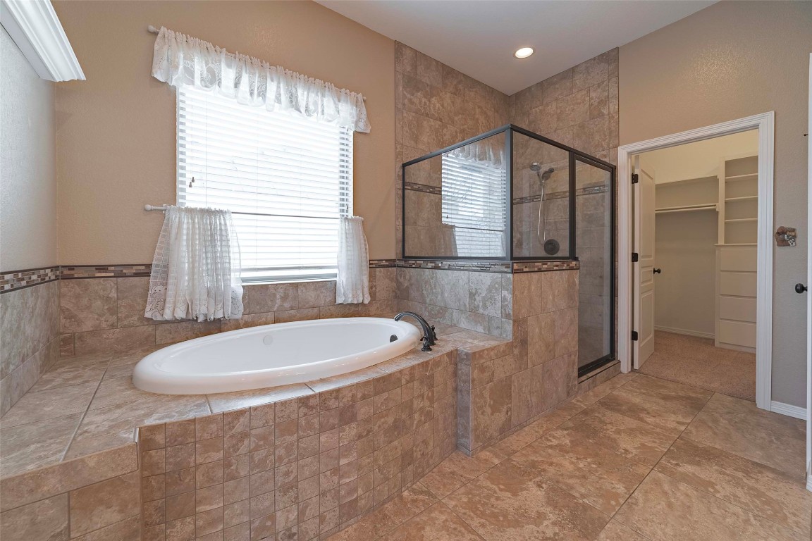 125 Walter Way Jarrell, TX 76537 - Photo 24 of 40 Full bath with a garden tub, a spacious closet, and a stall shower