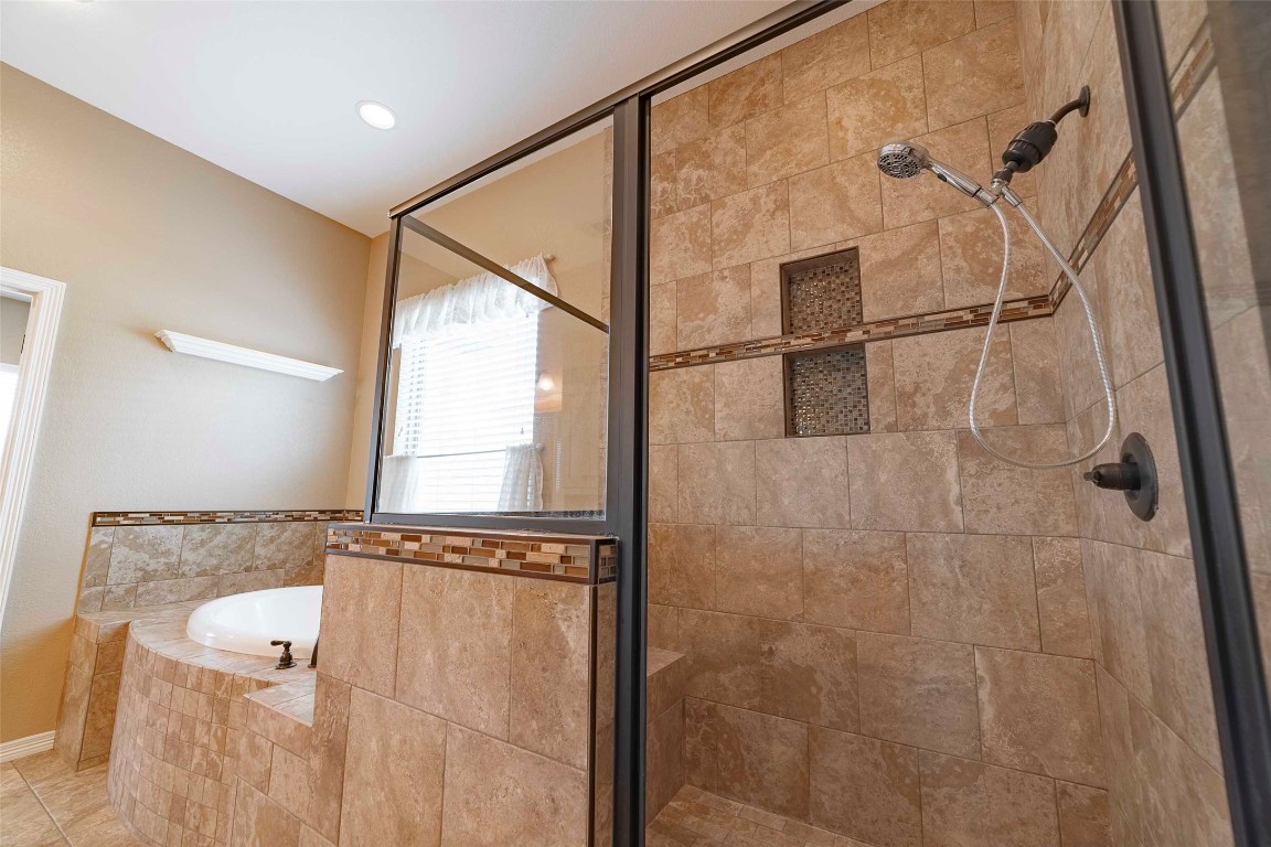 125 Walter Way Jarrell, TX 76537 - Photo 26 of 40 Full bathroom featuring a garden tub and a shower stall