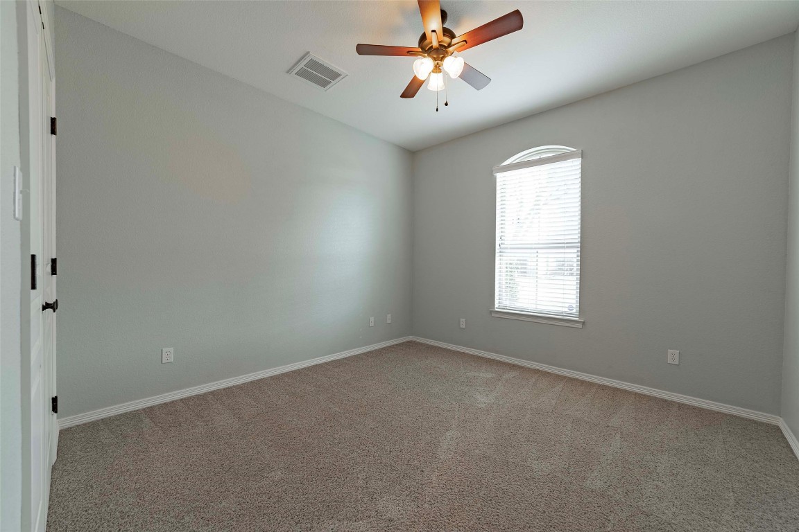 125 Walter Way Jarrell, TX 76537 - Photo 29 of 40 Carpeted spare room featuring baseboards and a ceiling fan