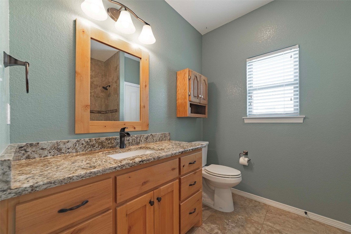 125 Walter Way Jarrell, TX 76537 - Photo 31 of 40 Full bathroom with vanity, a textured wall, and a shower