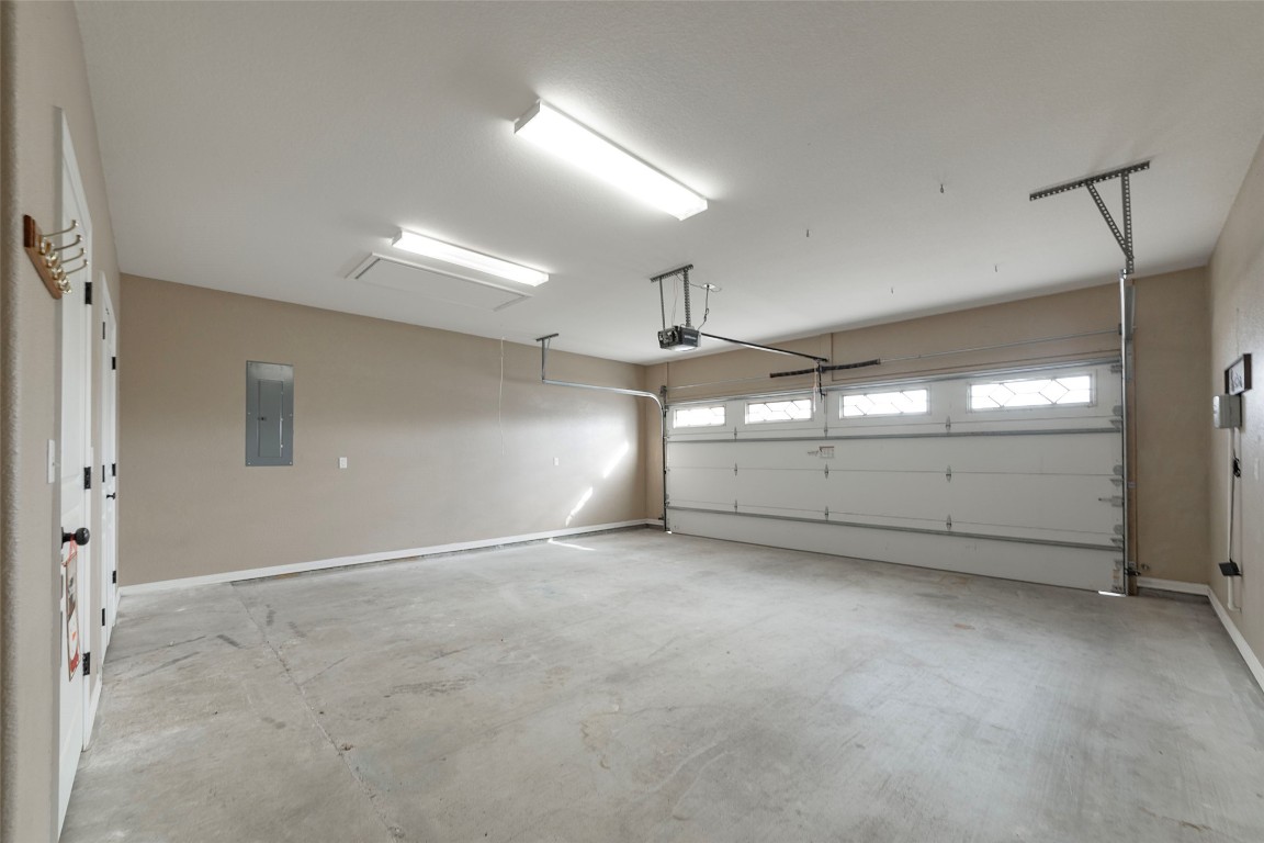 125 Walter Way Jarrell, TX 76537 - Photo 34 of 40 Garage featuring electric panel and baseboards