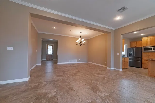 a view of a hallway with wooden floor and a living room