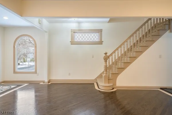 a view of an entryway with wooden floor