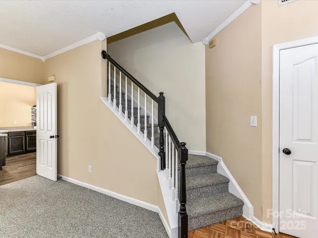 a view of a hallway with wooden floor and entryway