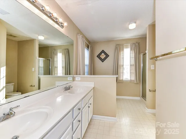 a spacious bathroom with a bathtub sink and mirror