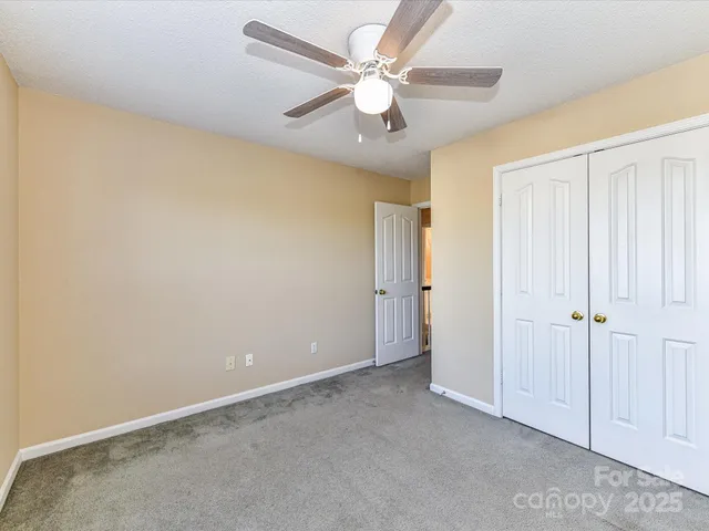 an empty room with fan and a ceiling fan