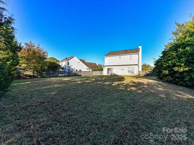 a view of backyard with large trees