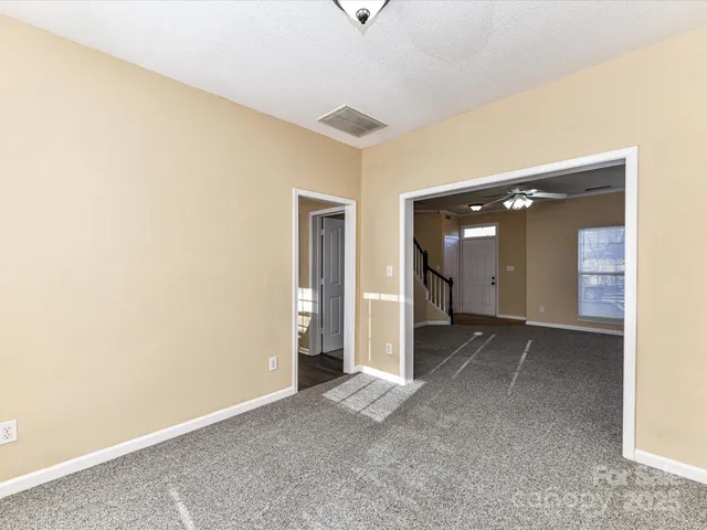 a view of a livingroom with wooden floor and cabinet