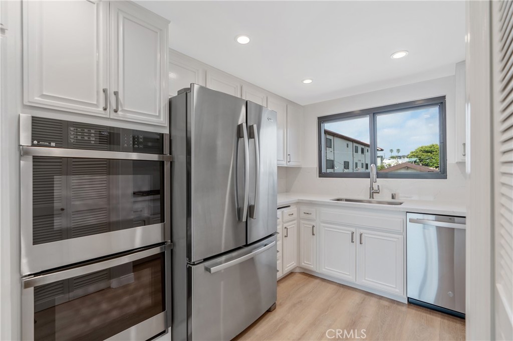 900 Cedar Street, Unit 308 El Segundo, CA 90245 - Photo 11 of 29 a kitchen with stainless steel appliances granite countertop a refrigerator and a stove top oven