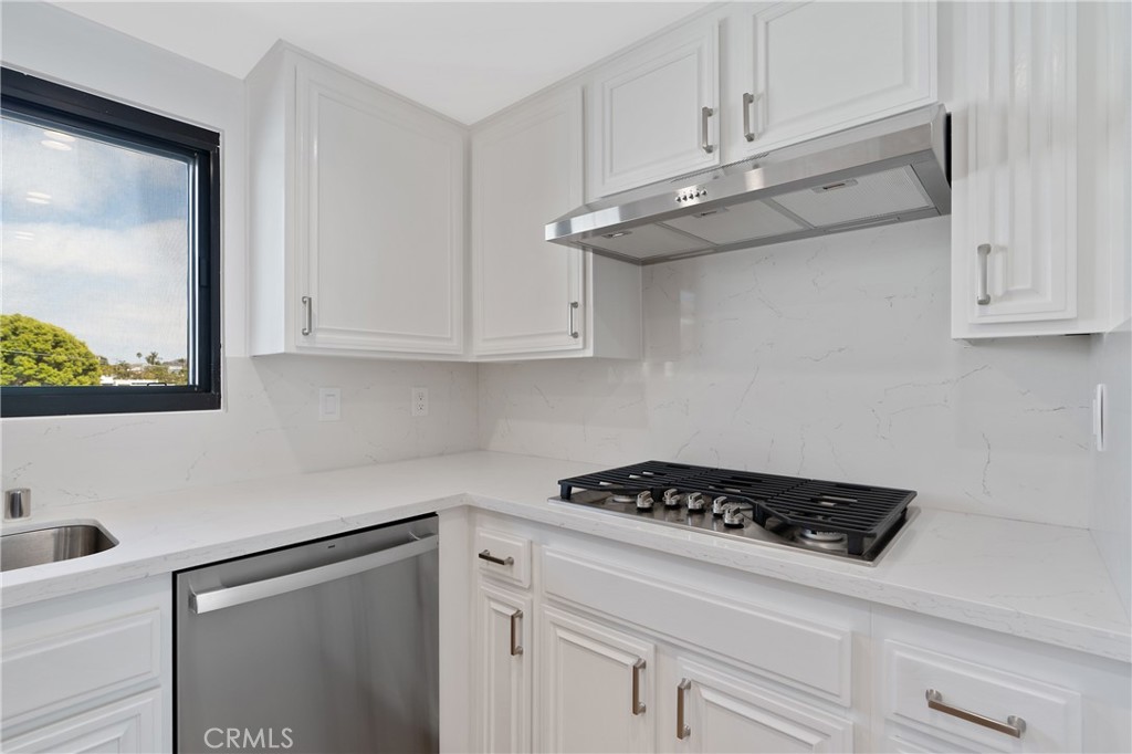900 Cedar Street, Unit 308 El Segundo, CA 90245 - Photo 13 of 29 a kitchen with white cabinets and black appliances