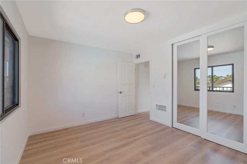 900 Cedar Street, Unit 308 El Segundo, CA 90245 - Photo 20 of 29 an empty room with wooden floor and windows