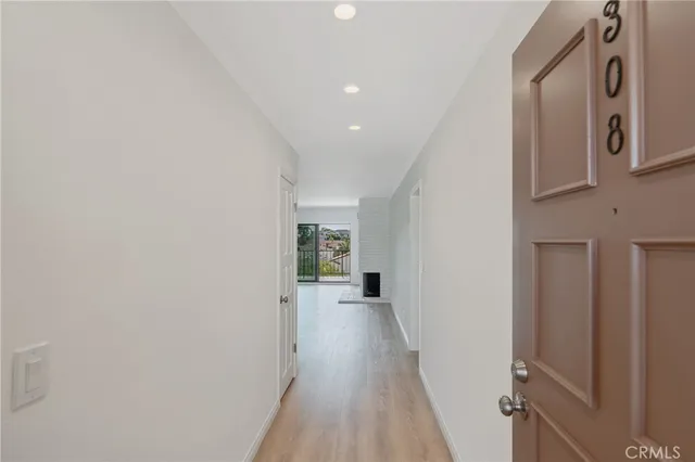 a view of a hallway with wooden floor