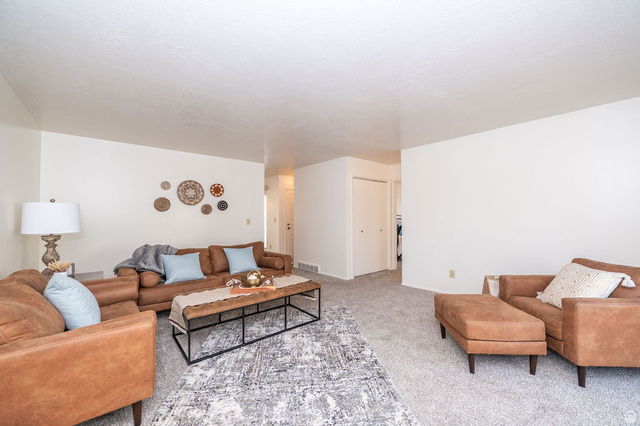 621 Coachman Way Riverdale, UT 84405 - Photo 15 of 38 Living room with light carpet