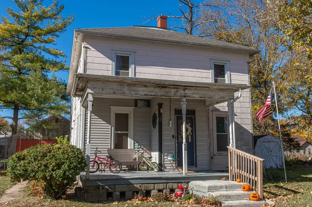 a view of a house with potted plants