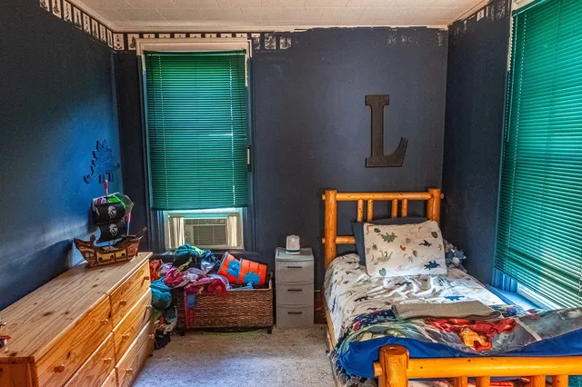 a bedroom with a bed and a window