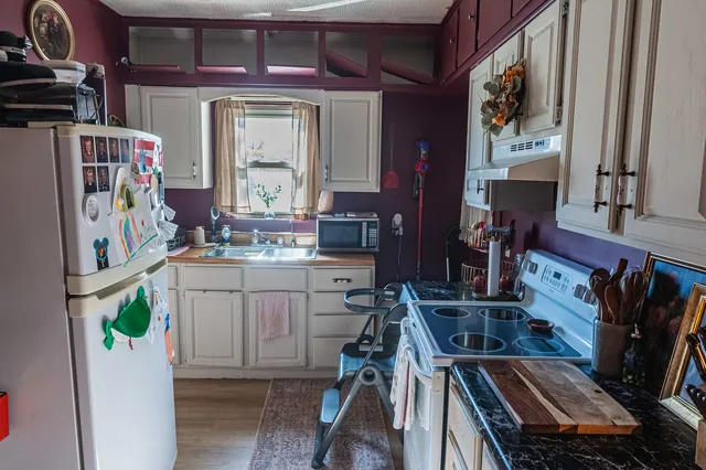 a kitchen with a stove a sink and a microwave