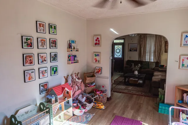 a room with toys and a wooden floor