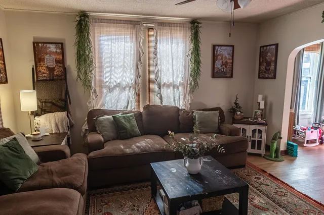 a living room with furniture and wooden floor