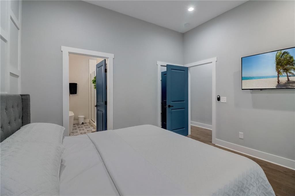 975 Welch Street Southwest Atlanta, GA 30310 - Photo 13 of 27 a bedroom with a large bed and a chandelier