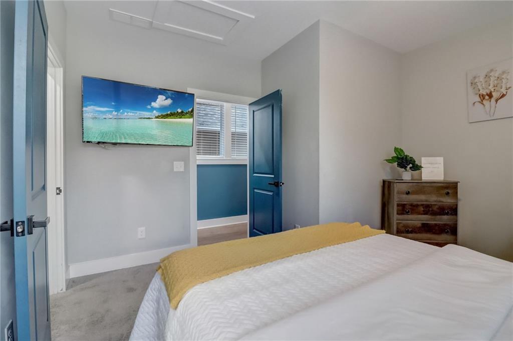 975 Welch Street Southwest Atlanta, GA 30310 - Photo 19 of 27 a bedroom with a bed and a flat screen tv
