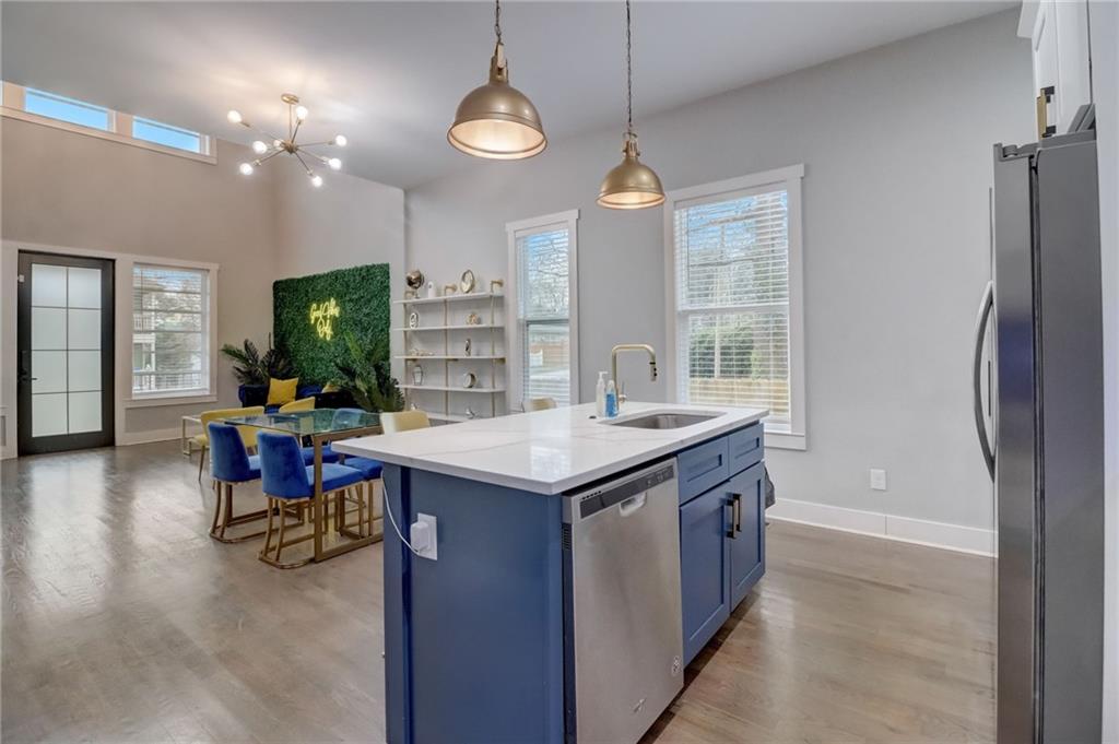 975 Welch Street Southwest Atlanta, GA 30310 - Photo 9 of 27 a kitchen with kitchen island a counter space a sink appliances and a dining table