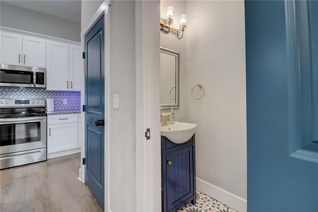 975 Welch Street Southwest Atlanta, GA 30310 - Photo 10 of 27 a kitchen with stainless steel appliances a sink and cabinets
