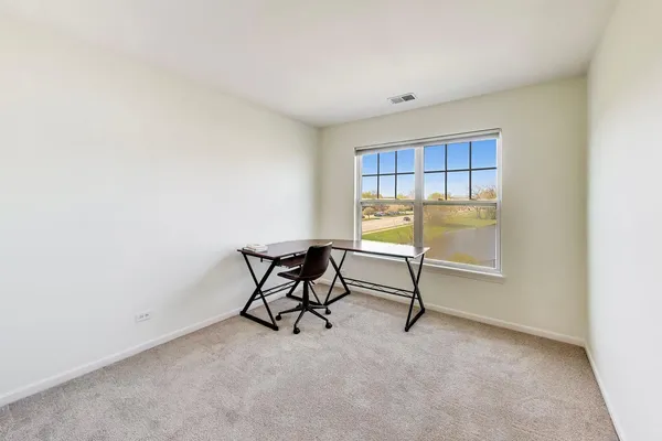 a view of a livingroom with furniture and a window