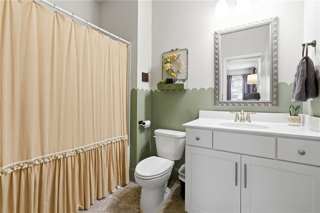 121 Treeline Trail Canton, GA 30115 - Photo 12 of 26 a bathroom with a toilet a sink and a mirror
