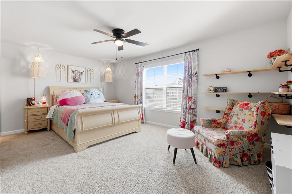 121 Treeline Trail Canton, GA 30115 - Photo 18 of 26 a bedroom with a bed and a chandelier