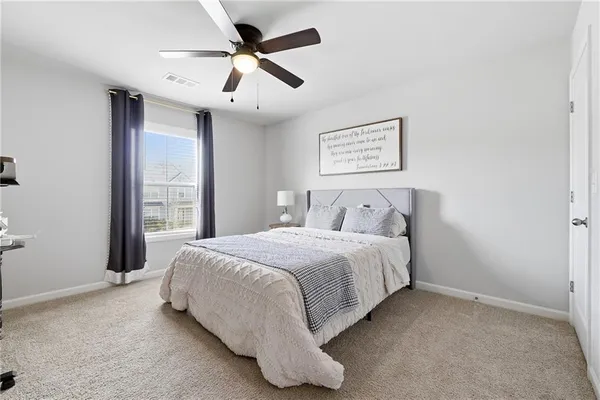 a bedroom with two beds and a window