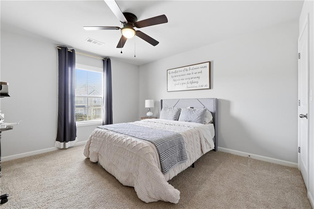 121 Treeline Trail Canton, GA 30115 - Photo 20 of 26 a spacious bedroom with a bed and a ceiling fan