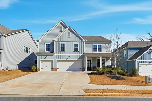a front view of a house with yard and balcony