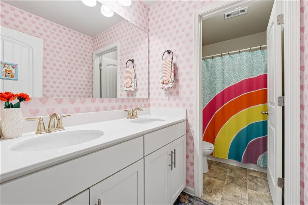 121 Treeline Trail Canton, GA 30115 - Photo 22 of 26 a bathroom with a sink and mirror
