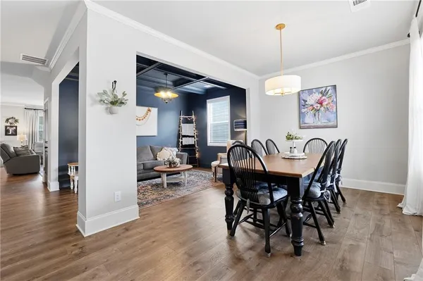 a view of a dining room with furniture and wooden floor