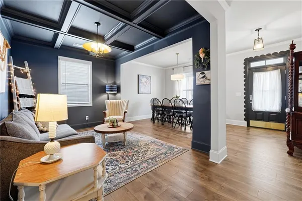 a living room with furniture and a wooden floor