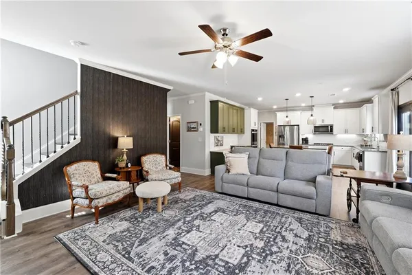 a living room with furniture and kitchen view