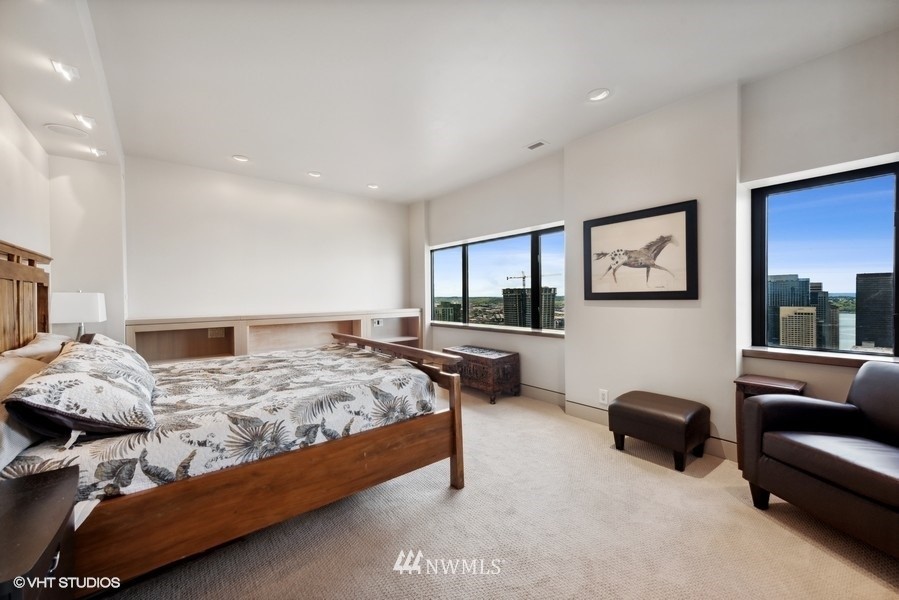 1301 Spring Street, Unit 30J Seattle, WA 98104 - Photo 14 of 40 a bedroom with a bed a couch and dresser