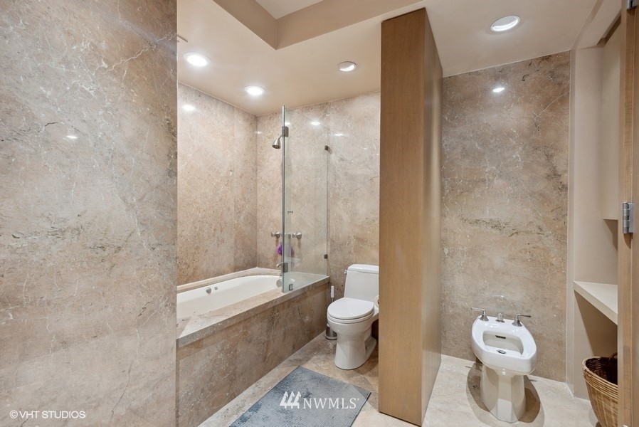 1301 Spring Street, Unit 30J Seattle, WA 98104 - Photo 16 of 40 a bathroom with a double vanity sink toilet and shower