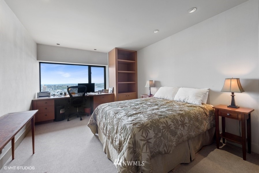 1301 Spring Street, Unit 30J Seattle, WA 98104 - Photo 17 of 40 a bedroom with a bed and a dresser