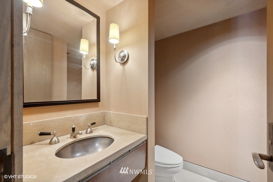 1301 Spring Street, Unit 30J Seattle, WA 98104 - Photo 18 of 40 a bathroom with a sink and a mirror
