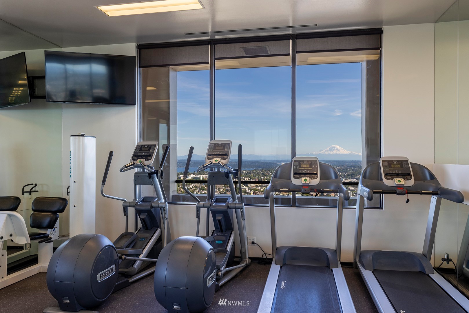 1301 Spring Street, Unit 30J Seattle, WA 98104 - Photo 24 of 40 a view of a workspace with furniture and wooden floor