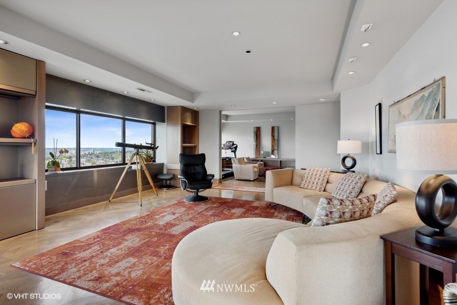 1301 Spring Street, Unit 30J Seattle, WA 98104 - Photo 3 of 40 a living room with furniture a dining table and a rug
