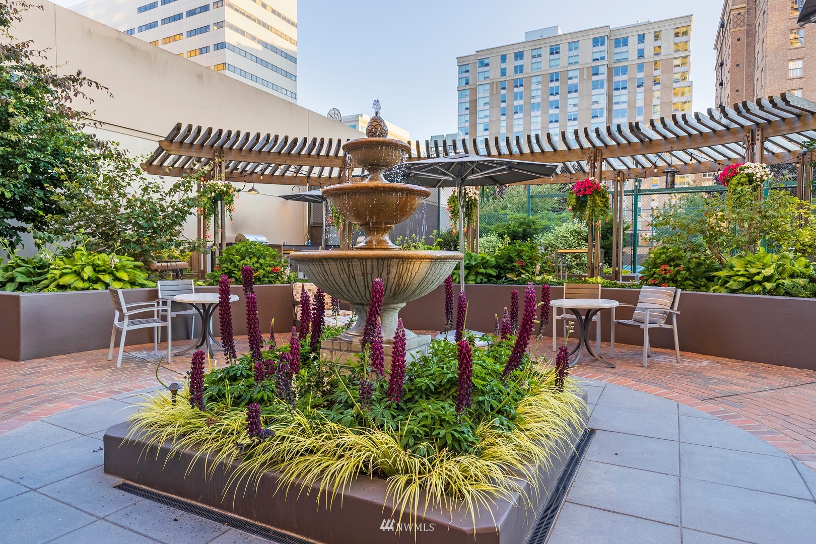1301 Spring Street, Unit 30J Seattle, WA 98104 - Photo 34 of 40 a view of a chairs and table in the patio