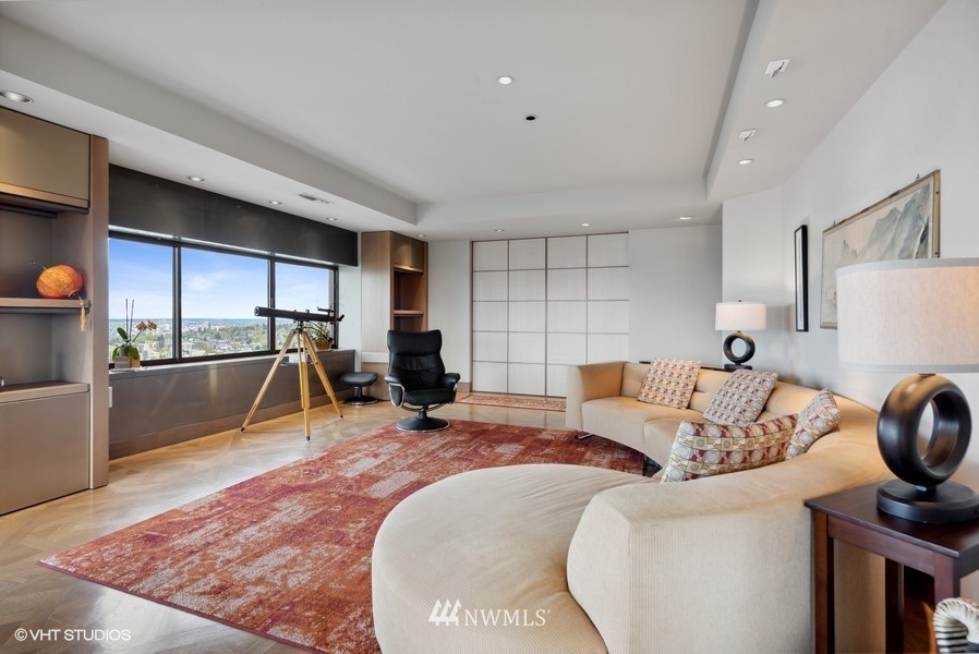 1301 Spring Street, Unit 30J Seattle, WA 98104 - Photo 4 of 40 a living room with furniture a rug and a view of living room