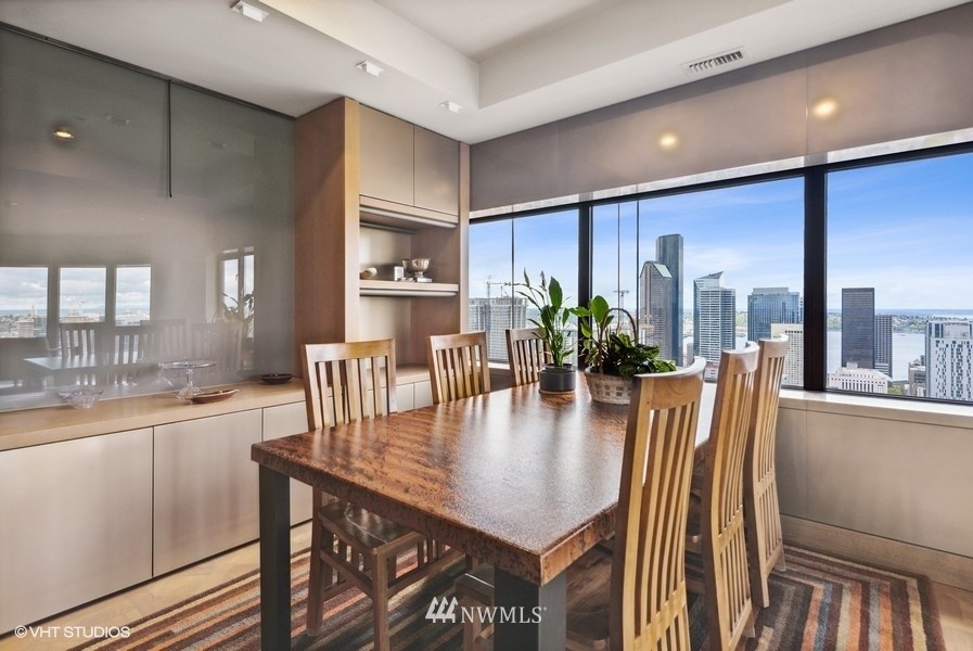 1301 Spring Street, Unit 30J Seattle, WA 98104 - Photo 7 of 40 a dining room with furniture and window